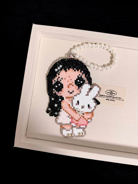 Second product photo of handmade pixel bead charm featuring a pink girl holding a white bunny