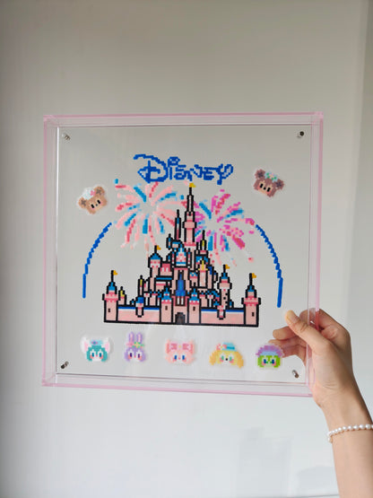 Handheld view of handmade pink fairytale castle pixel bead acrylic frame