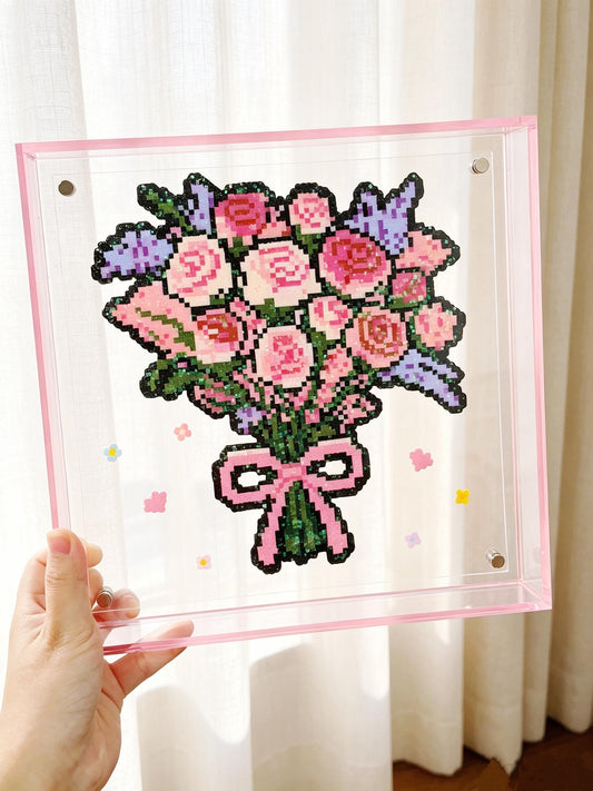 Handmade pink rose bouquet pixel bead acrylic frame held in natural light